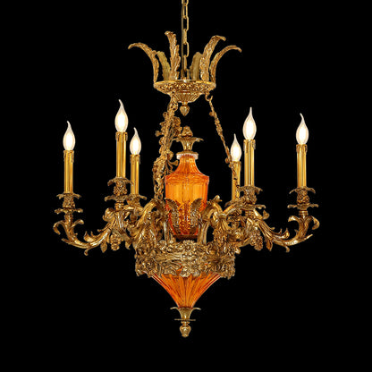 Pomme d'Orange Baroque brass chandelier with orange glass and eight candle bulbs on black.