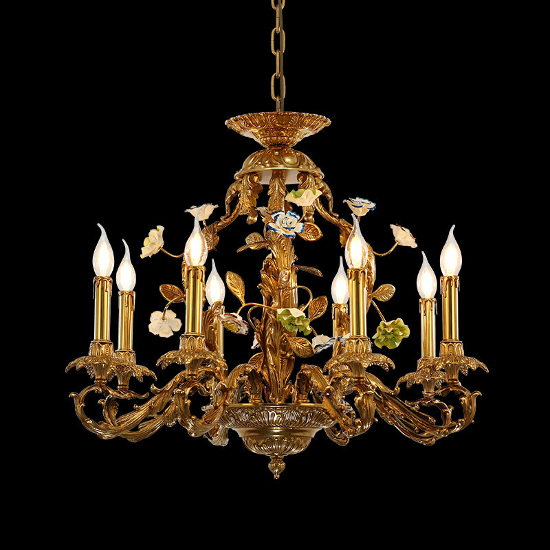 Close-up front view of the ornate brass and multi-colored ceramic blossom chandelier on black.