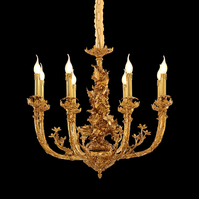 Detailed side view of the chandelier's ornate brass column, candle bulbs, and floral.