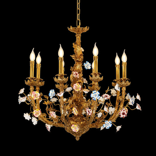 Close-up of Pompadour's Porcelain Bloom brass chandelier with multi-colored ceramic flowers on black.