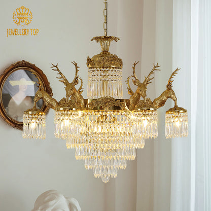 Wide angle view of the luxury crystal chandelier illuminating an elegant villa interior with classic wall moldings.