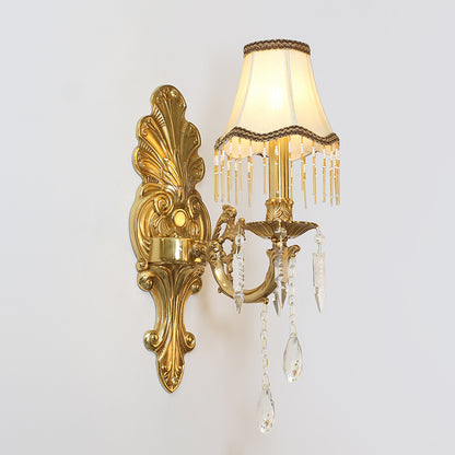 Extreme close-up macro detail of the sconce’s intricate brass scrollwork, floral carvings, and crystal beads.