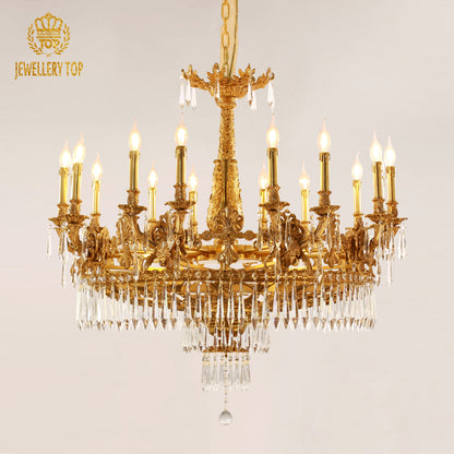 An ornate brass chandelier hanging in a high-ceilinged room, showcasing its grand scale and craftsmanship.
