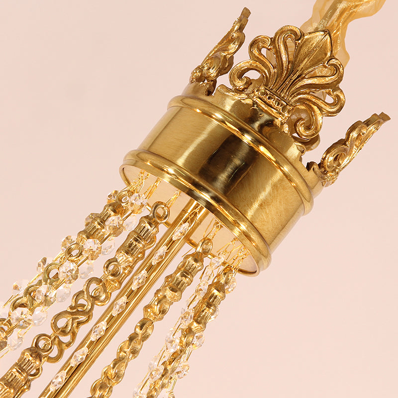 Macro close-up of the Fleur-de-lis motif and the ribbed, amber-tinted crystal elements.