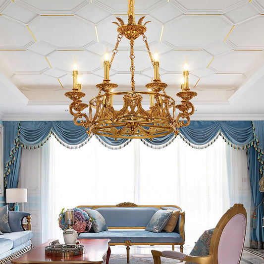 A living room luxury chandelier installed in a stylish lounge with a coffered ceiling and classic blue drapery.