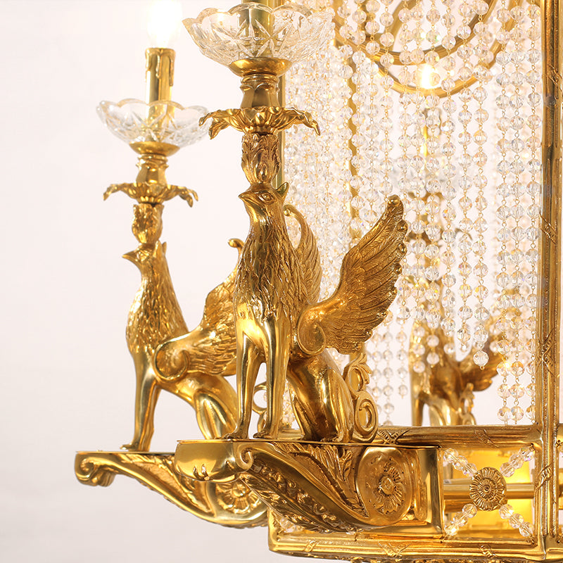 Macro close-up of the finely detailed golden winged griffin sculpture wrapped with crystal beaded chains.