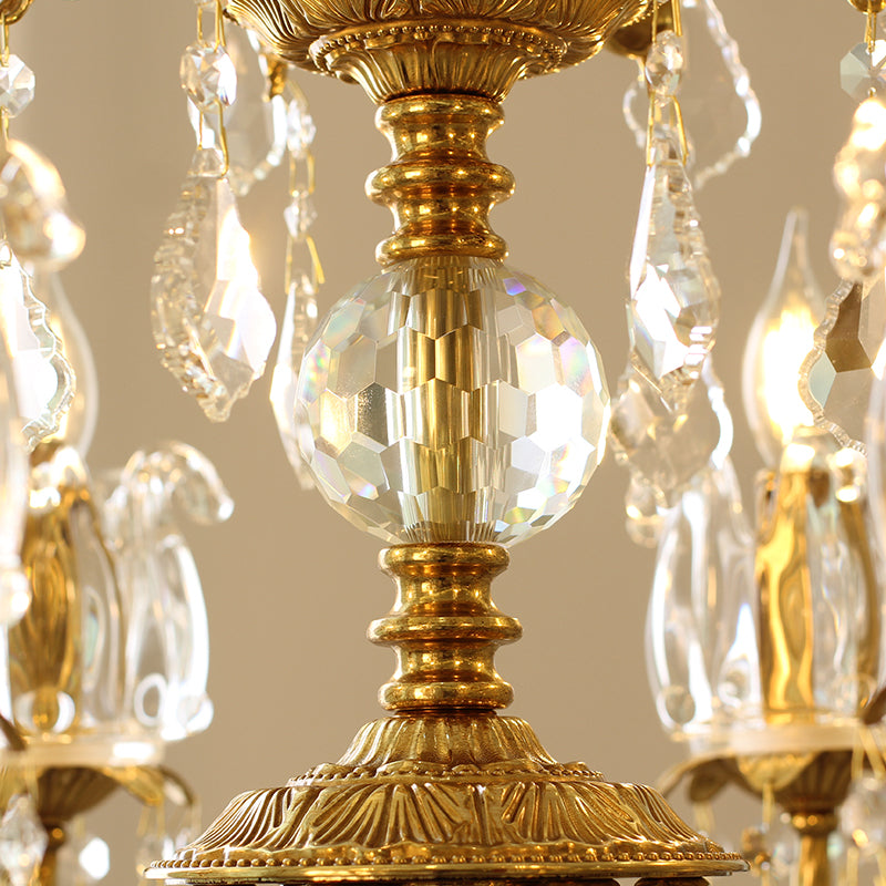xtreme close-up of a central crystal sphere and intricate brasswork on the chandelier.