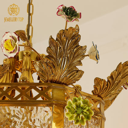 Macro close-up of the finely detailed polychrome enamel flowers and the textured etched glass panels.