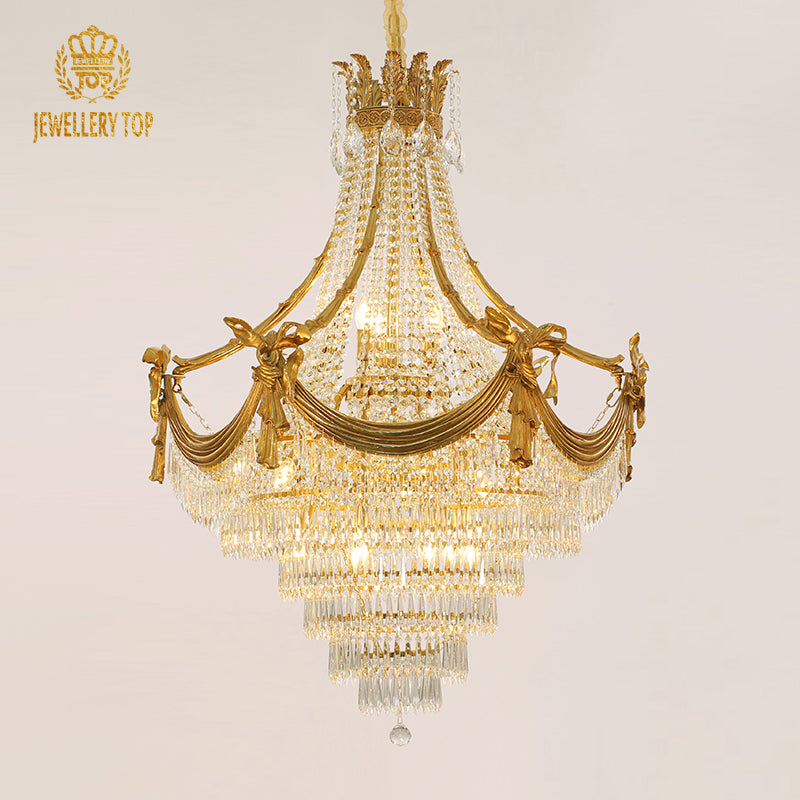 A large size luxury chandelier installed in a grand villa lobby with marble walls and a high ceiling.