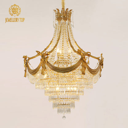A large size luxury chandelier installed in a grand villa lobby with marble walls and a high ceiling.