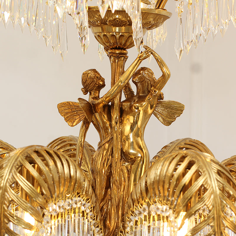 Close-up of the intricate winged dancer figurines on the central column of a crystal brass chandelier.