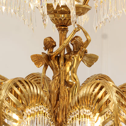 Close-up of the intricate winged dancer figurines on the central column of a crystal brass chandelier.