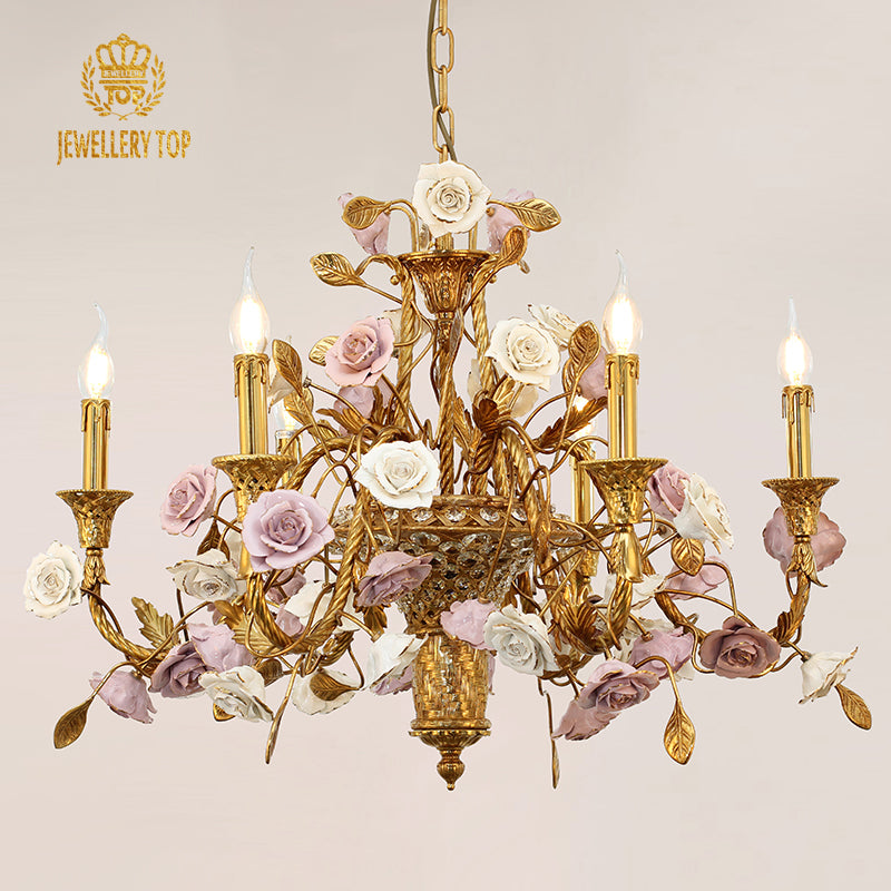 Front view of a JEWELLERY TOP brass chandelier with a central vase and ceramic rose decorations.