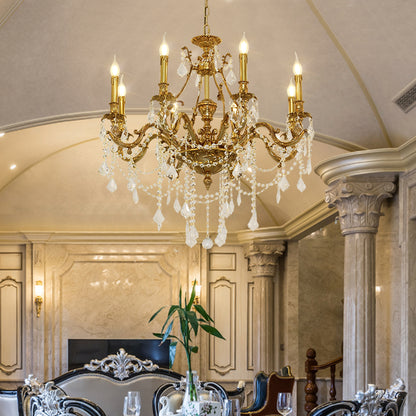 The crystal brass chandelier installed in an elegant dining room with columns and a set table.