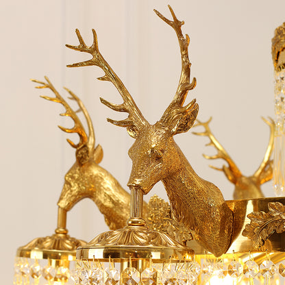 Macro close-up of the finely detailed deer head carvings and the textured bark-like finish on the solid brass frame.