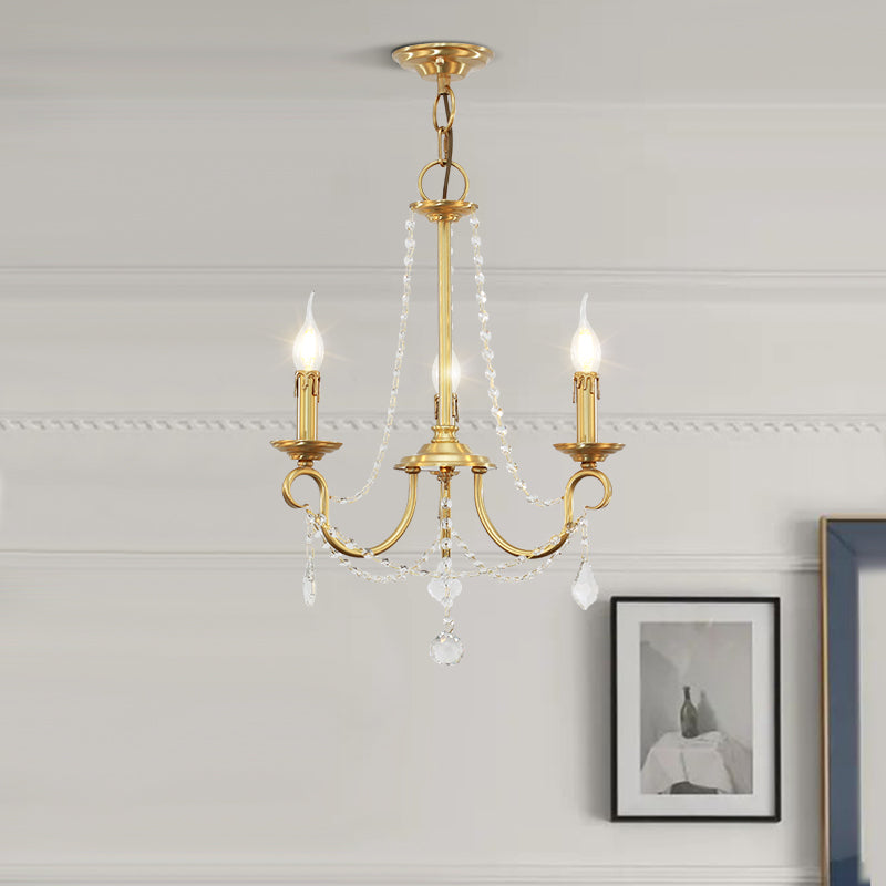 Classic French style miniature chandelier with glowing candle bulbs on a white ceiling.