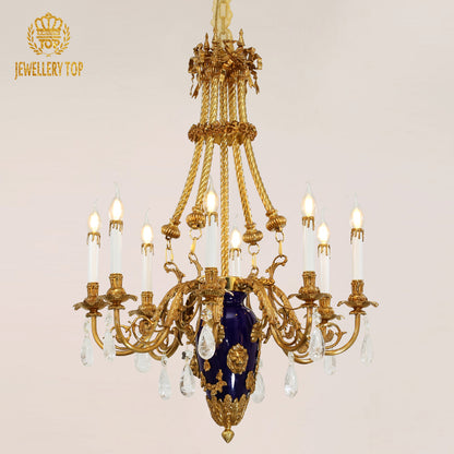 Front view of a golden French brass chandelier with a blue ceramic vase and crystal, brand visible.