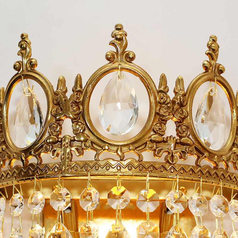 Macro close-up of the sparkling round crystal cascade and the intricate metalwork of this French luxury wall lamp.