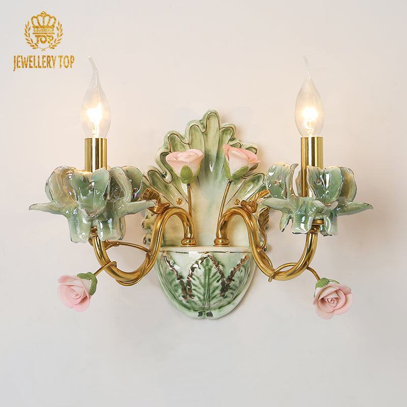 Side angle of the brass wall sconce highlighting the elegant arch of the arms and the candle bulbs.