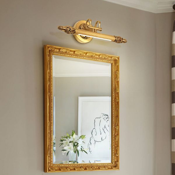 The French brass mirror wall lamp installed as a pair above a bathroom vanity with a large rectangular mirror.