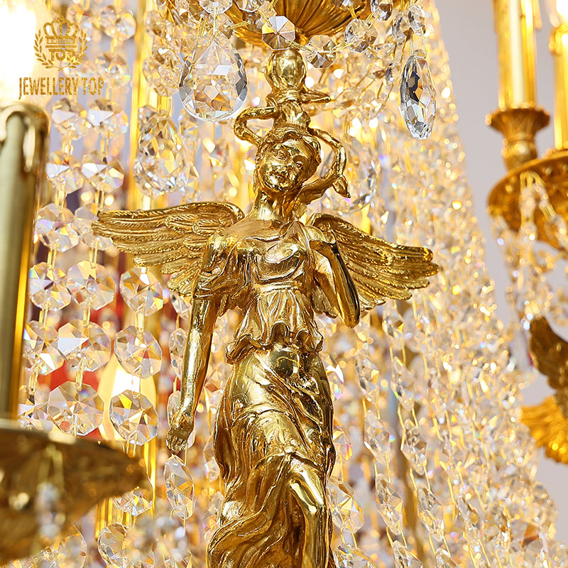 Detailed shot of the ornate brass arm, ruffled glass candle holders, and dangling crystal pendants.