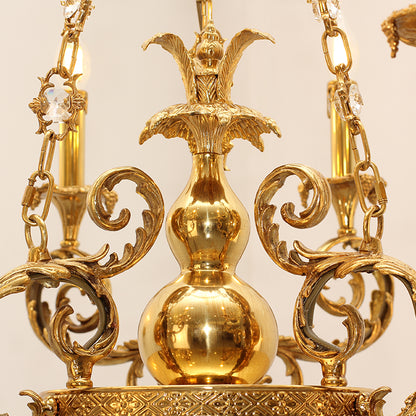 Top detail view of the chandelier’s fluted brass column and ornate canopy.