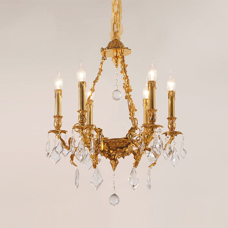 Front view of a six-light French Victorian crystal brass chandelier against a light wall.