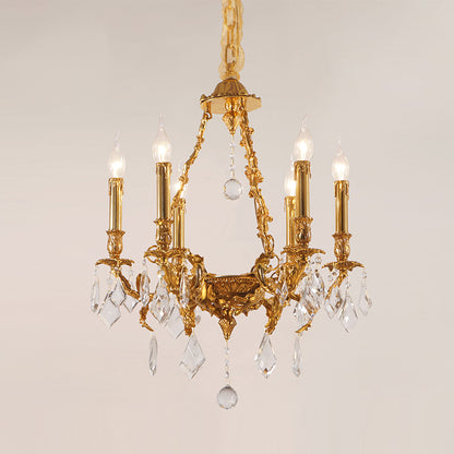 Front view of a six-light French Victorian crystal brass chandelier against a light wall.