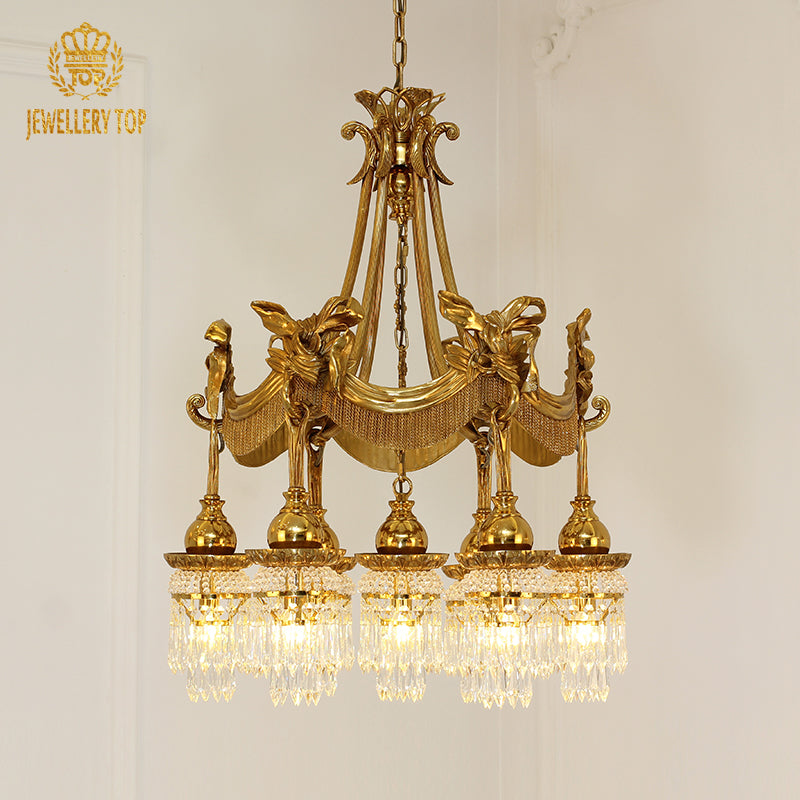 A luxurious living room interior featuring the large multi-tiered brass chandelier hanging below an ornate ceiling medallion.