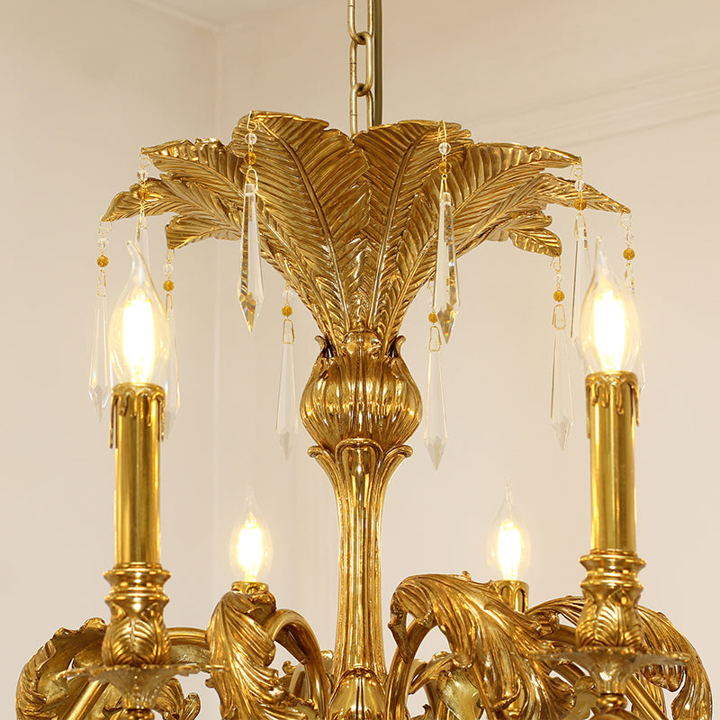 Macro close-up of the finely textured golden brass leaves and the delicate crystal drop pendants.