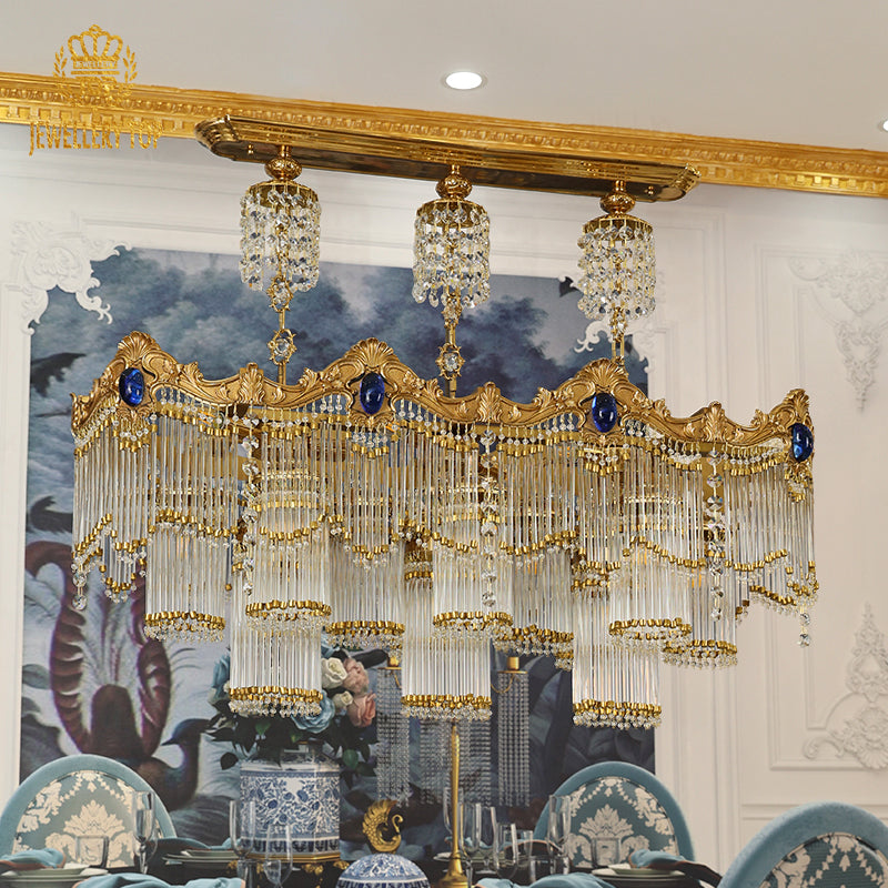 Angled perspective showcasing the tiered layers of hanging crystal strands and the elegant cylindrical glass shades.