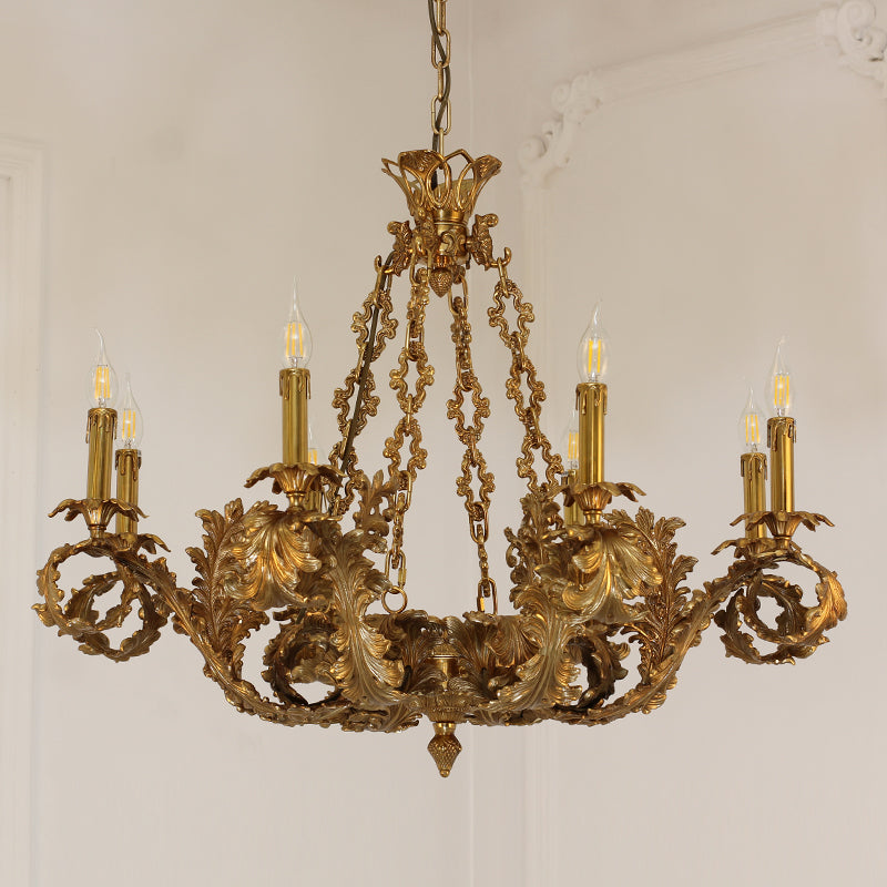 A classic brass chandelier with curved arms and leaf designs mounted on a white ceiling.