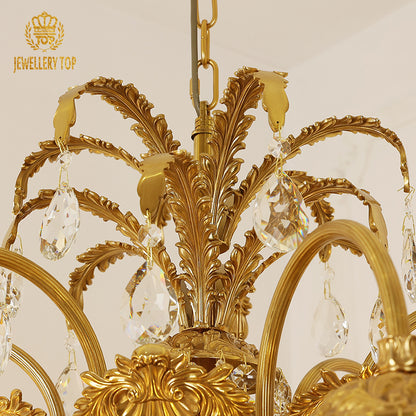 The luxury brass chandelier above a classic dining setting, radiating warm ambient light.