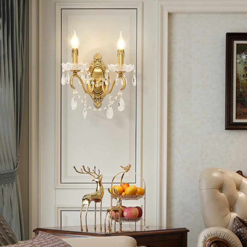 The installed luxury brass wall lamp in a white recessed wall niche with a fruit bowl and deer sculpture.