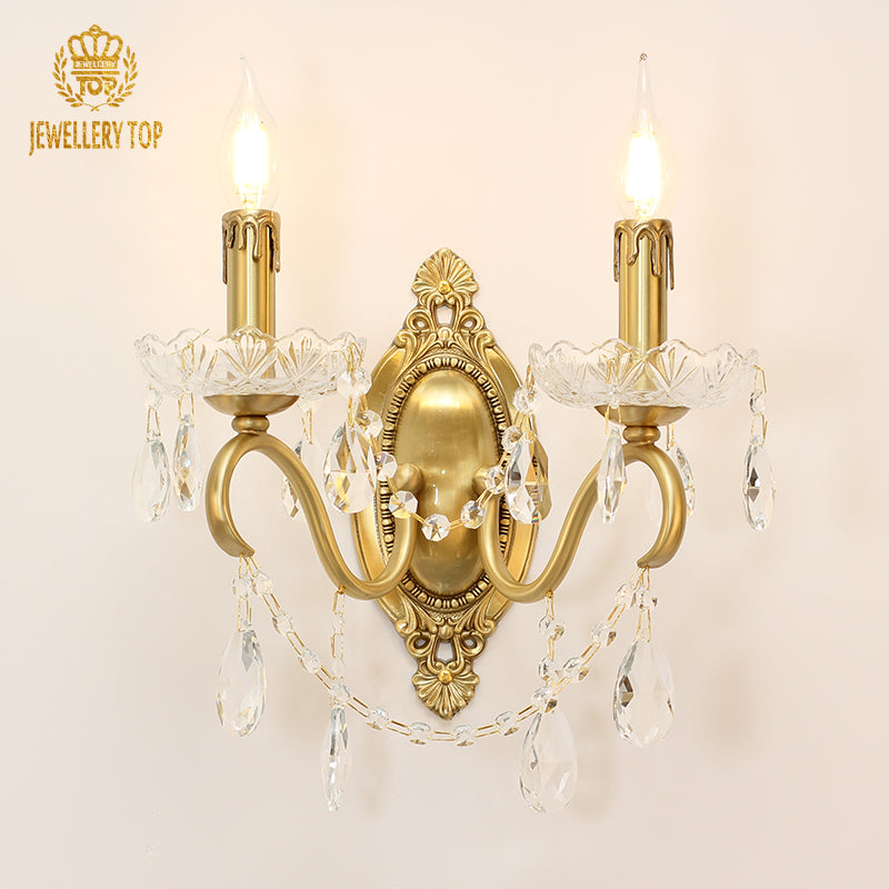 JEWELLERY TOP branded crystal wall sconce with two candle bulbs and ornate metalwork.