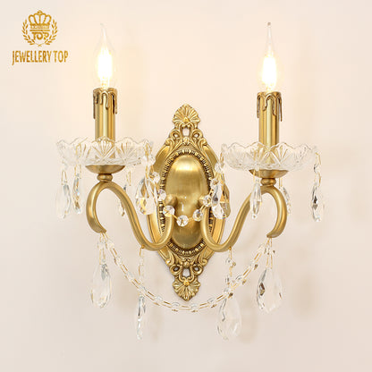 JEWELLERY TOP branded crystal wall sconce with two candle bulbs and ornate metalwork.