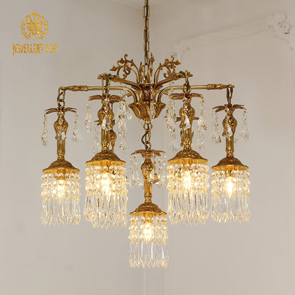 Angled perspective highlighting the symmetrical arrangement of lights and the elaborate foliate detailing on the brass frame.