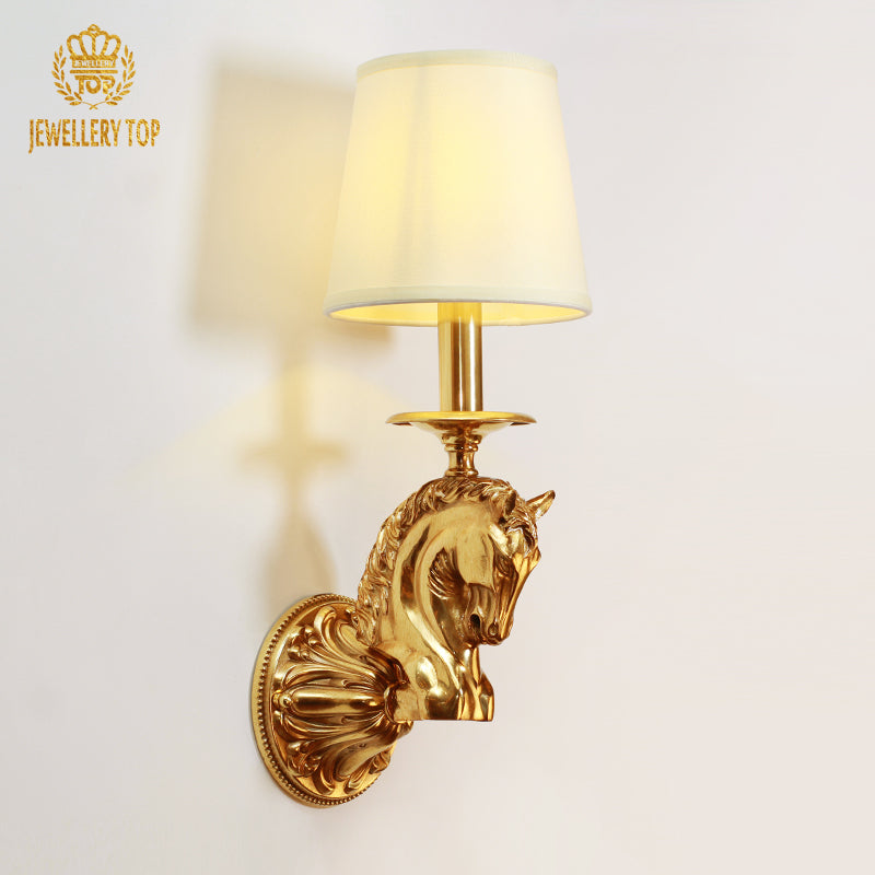 JEWELLERY TOP branded product image of the golden horse head wall light with a beige lampshade on a white backdrop.