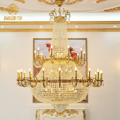Macro close-up of the finely detailed golden acanthus leaves and the teardrop crystal pendants.