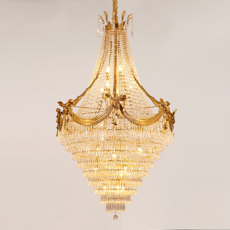Extreme detail shot of the elaborate gilded bow tie and cascading crystal pendants.