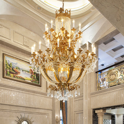 Hotel lobby scene featuring a majestic multi-tier brass and crystal chandelier, JEWELLERY TOP.
