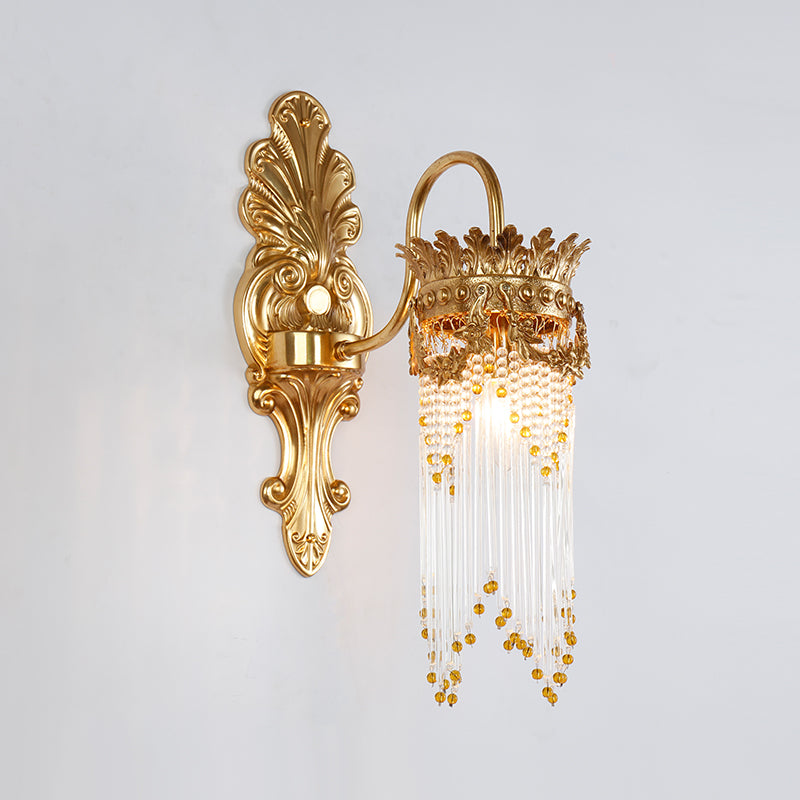 Detailed macro shot of the sconce’s lavish crystal and gold bead curtains, highlighting their sparkle and texture.