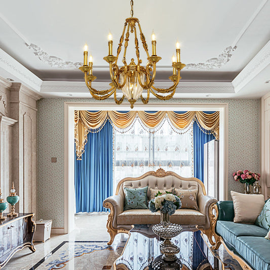 A french luxury chandelier installed in a lavish living room with ornate ceiling moldings and a plush sofa.