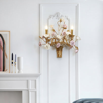 The brass and ceramic wall sconce installed on a white wall next to a fireplace and decorative artwork, showcasing its home decor appeal.