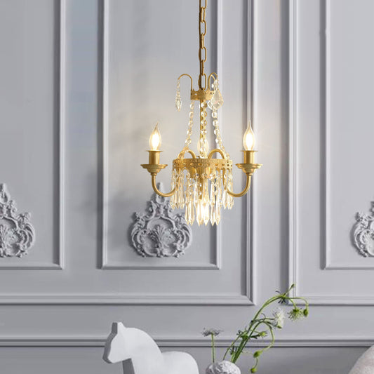 French brass crystal chandelier with three candle bulbs on a classically paneled wall.