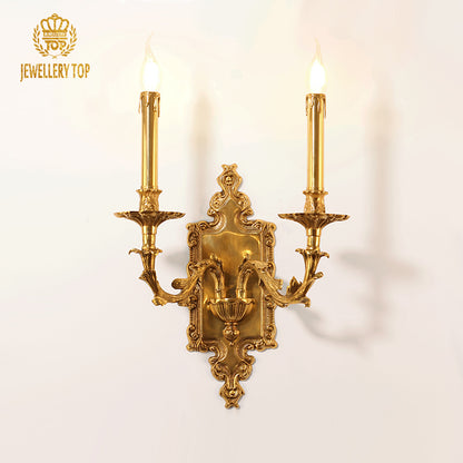 Close-up of the JEWELLERY TOP branded brass sconce, highlighting the crystal teardrops and metal craftsmanship.