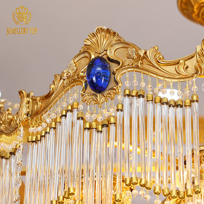 Macro close-up of the deep blue sapphire-like crystal embellishments embedded in the ornate golden frame.