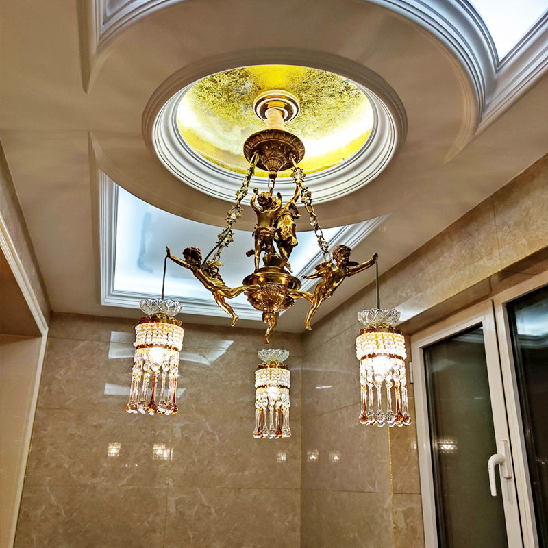 The brass chandelier installed in a coffered ceiling recess against a marble wall background.