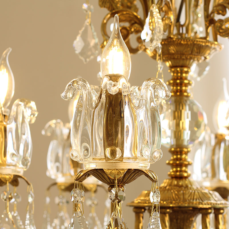 Detailed macro of a fluted glass candle cup, bulb, and hanging crystal strings.