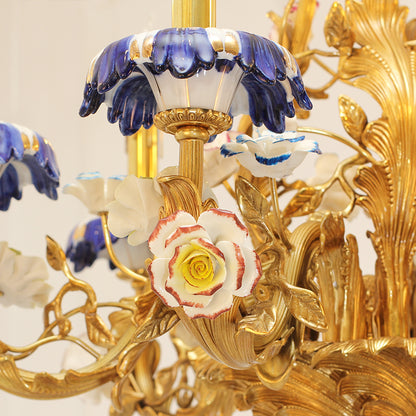Extreme close-up of a red and white ceramic rose and blue floral details on the brass chandelier.